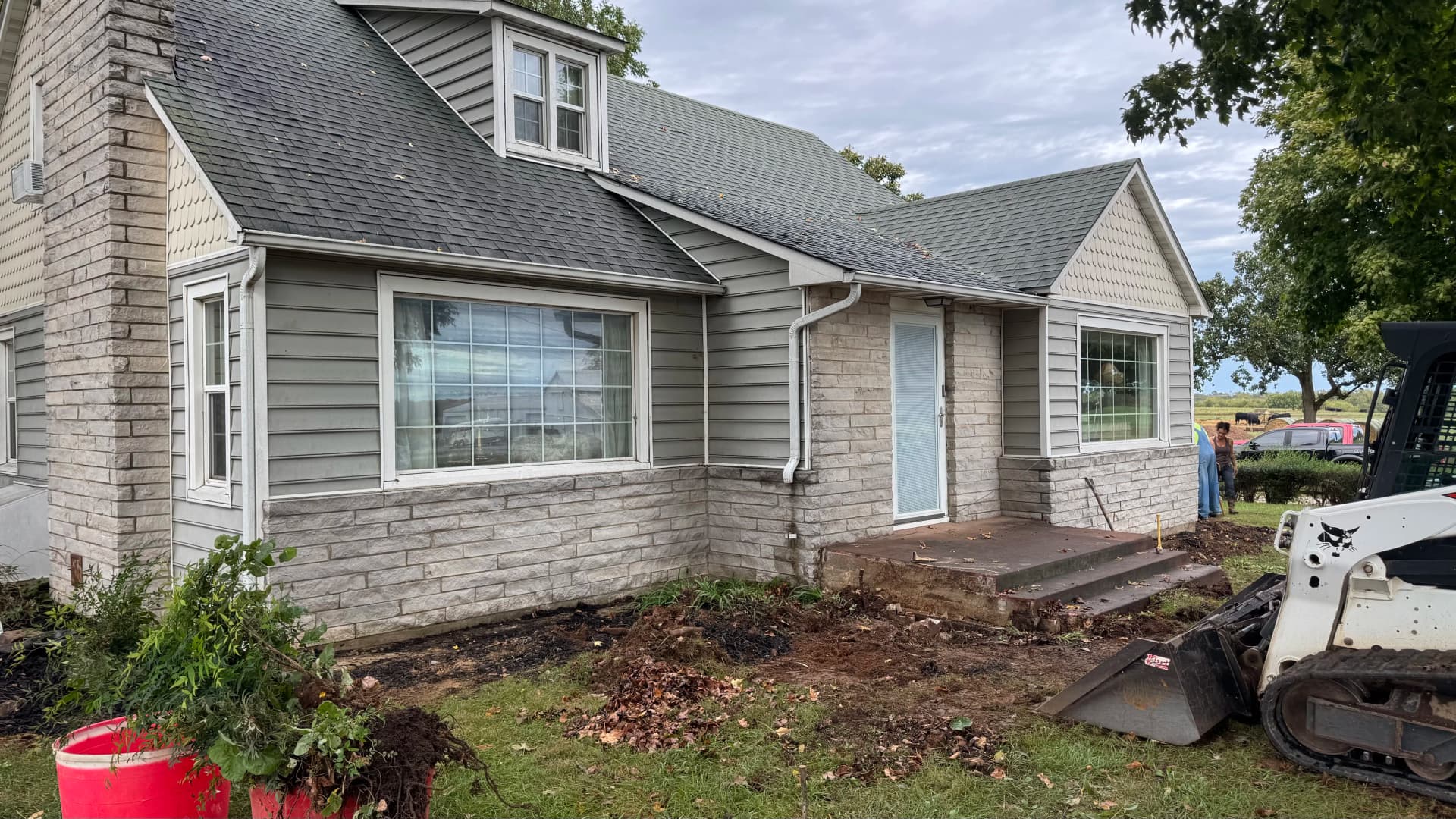 Old Front Steps Replaced With a Wide Concrete Patio and Entry image