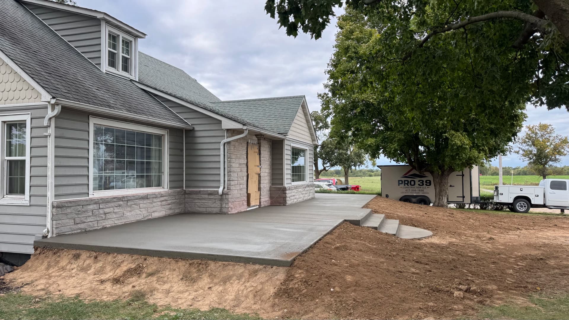 Gallery photos for Old Front Steps Replaced With a Wide Concrete Patio and Entry: Image #2