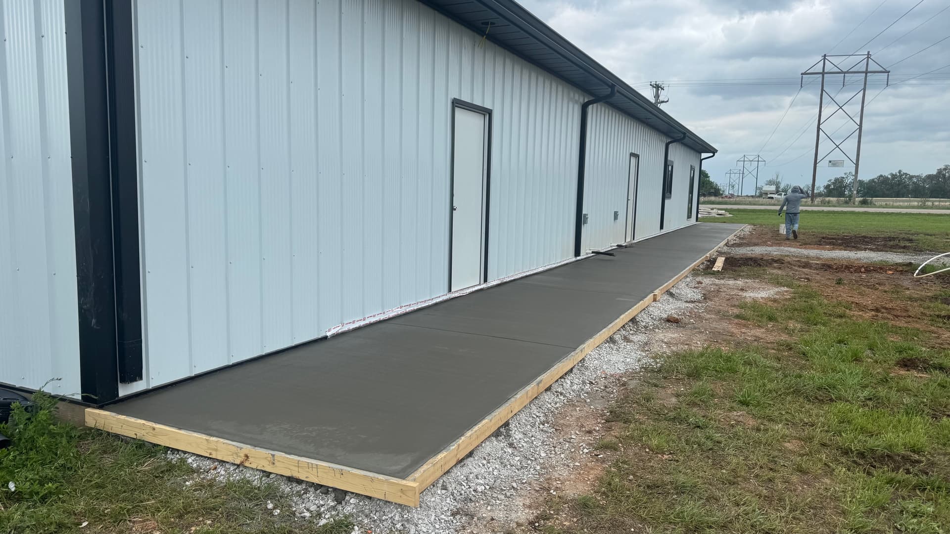 Wide Concrete Sidewalk Pour Along a Commercial Building image